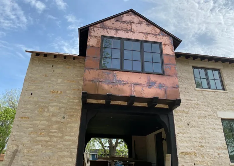 Copper metal panel facade on a stone building for Skylight Installation in Pleasant Run